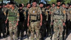 Kurdish-led forces in Syria dissolve after merging with the army