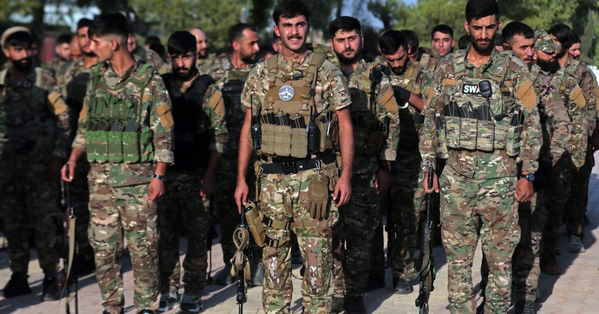 Kurdish-led forces in Syria dissolve after merging with the army