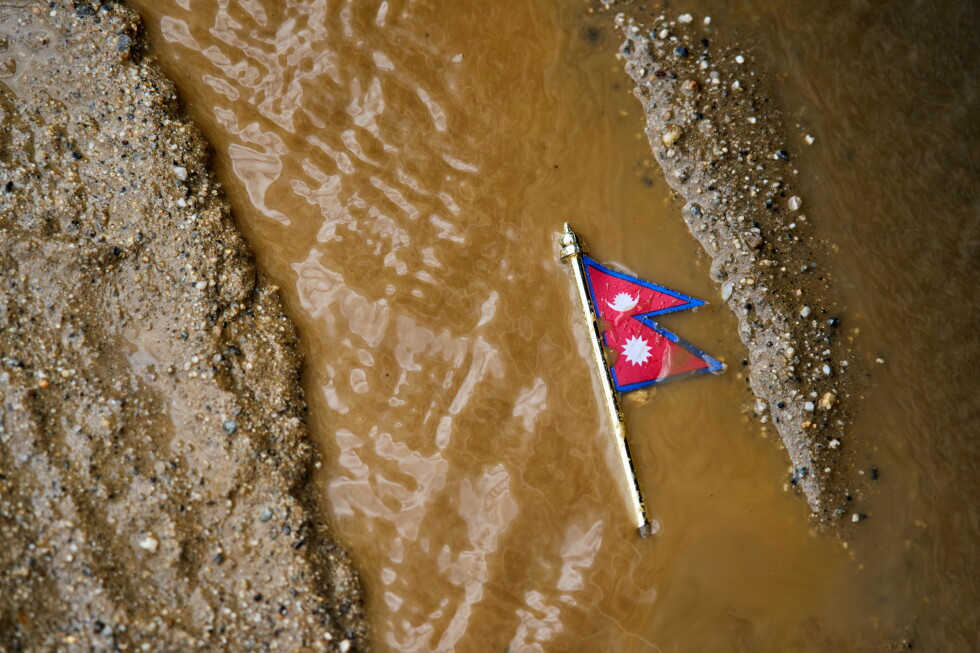 Rescuers comb through mud and debris as Nepal-China floods leave more than 1,000 dead