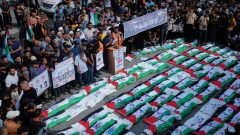 Palestinians in Gaza bury remains of 100 people recovered from rubble