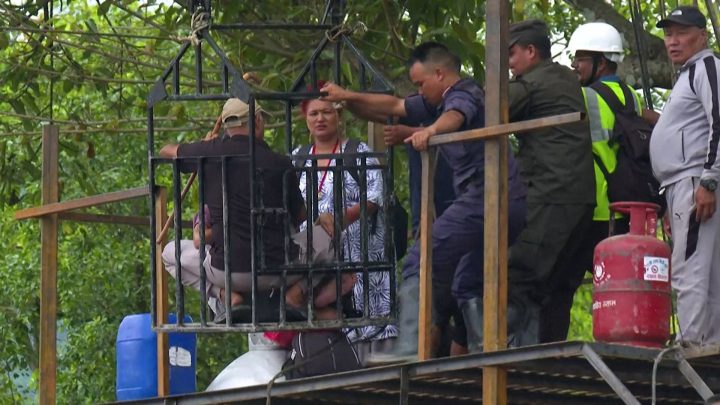 Stranded survivors in Nepal cross raging Trishuli River using zip line