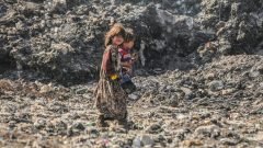 Displaced Syrians dig through hills of garbage to make a living