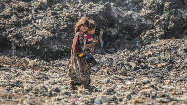 Displaced Syrians dig through hills of garbage to make a living