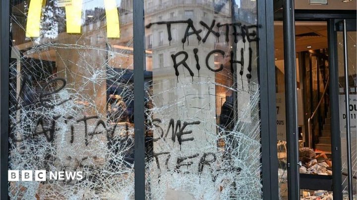 Burnt out cars and shattered glass on Paris streets after protests turn to riots and looting